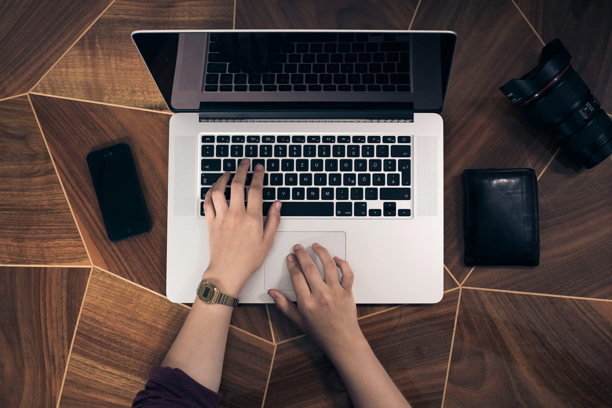 person typing at a laptop.
