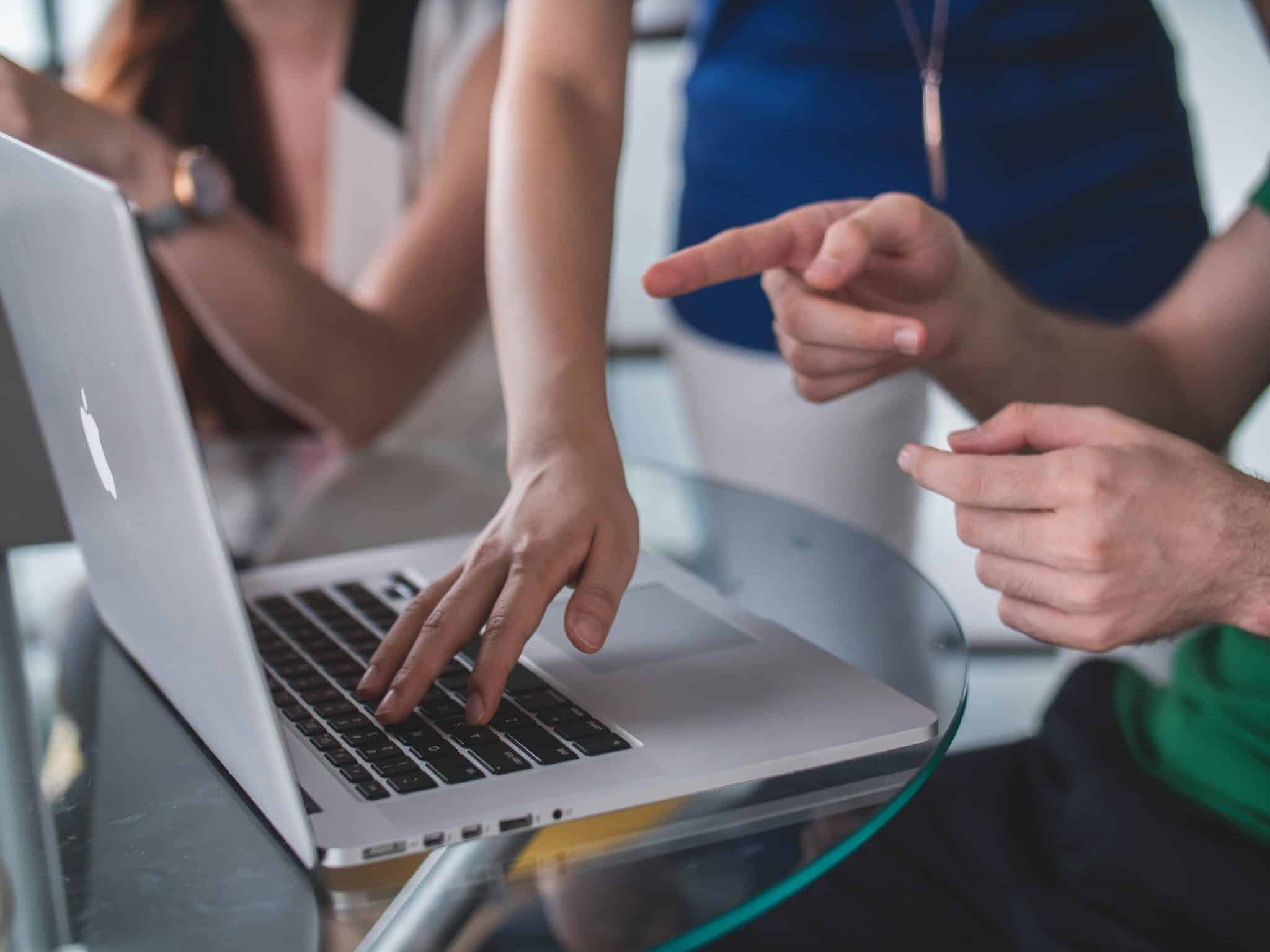 Two people looking at a laptop.
